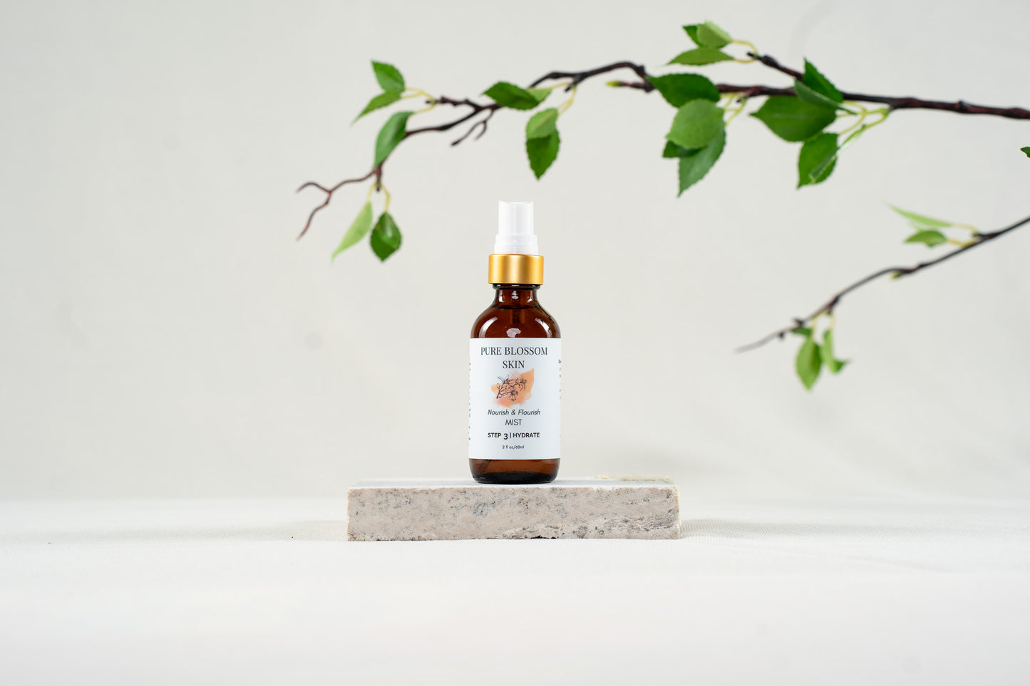2oz amber glass spray bottle w/matte gold trim of Nourish & Flourish MIST | Pure Blossom Skin