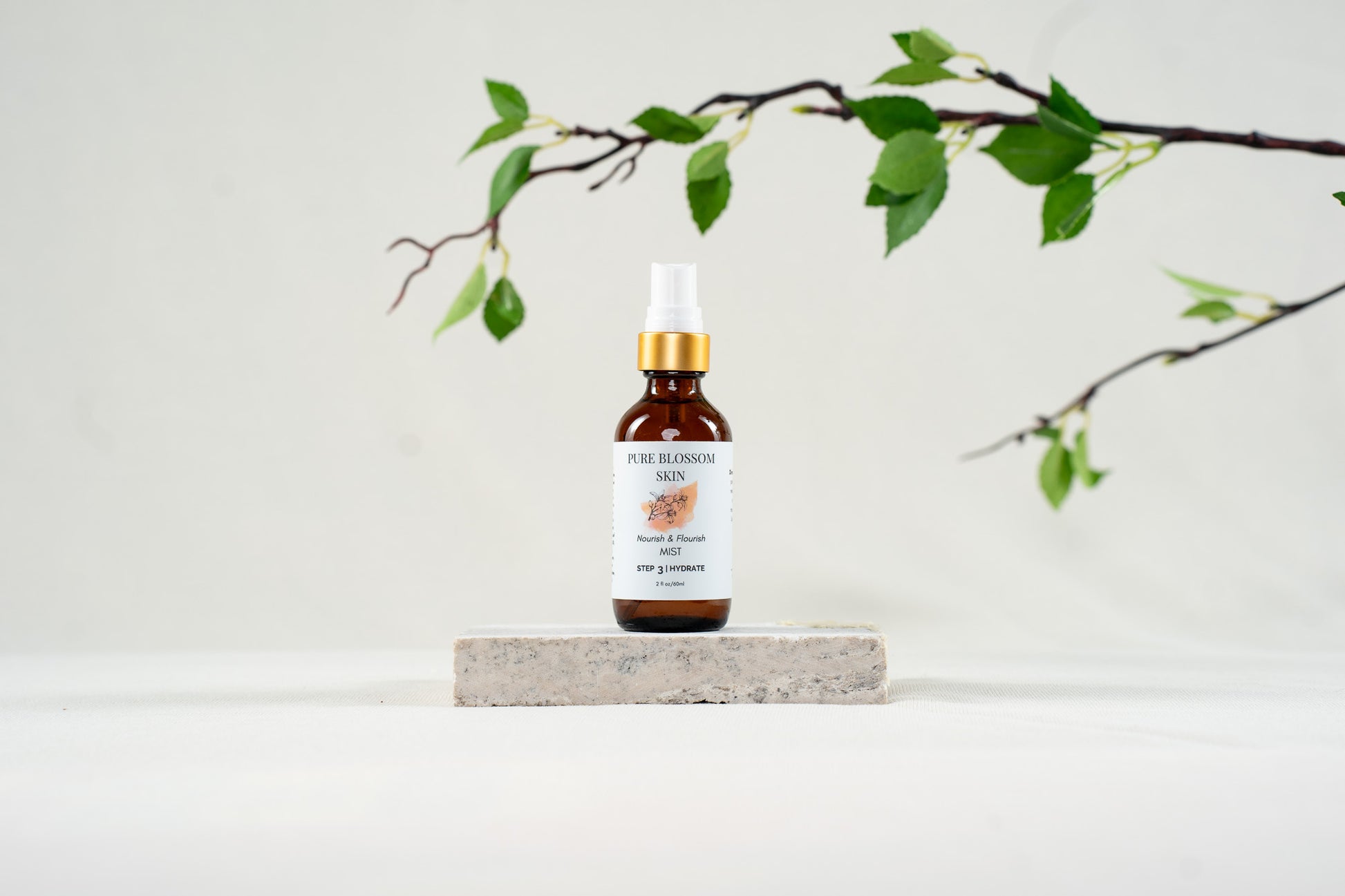 2oz amber glass spray bottle w/matte gold trim of Nourish & Flourish MIST | Pure Blossom Skin