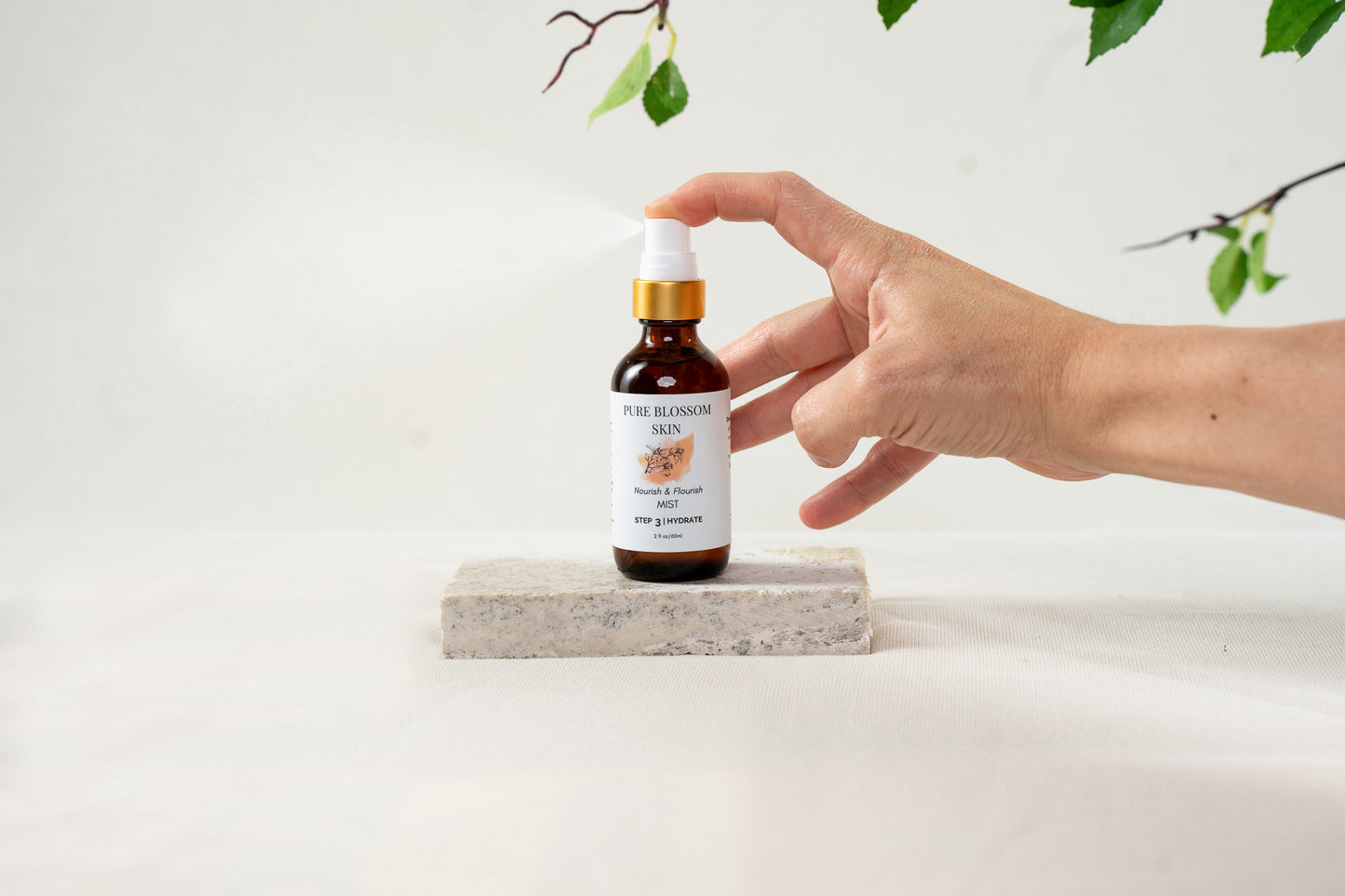 2oz amber glass spray bottle  w/matte gold trim spraying  Nourish & Flourish MIST | Pure Blossom Skin