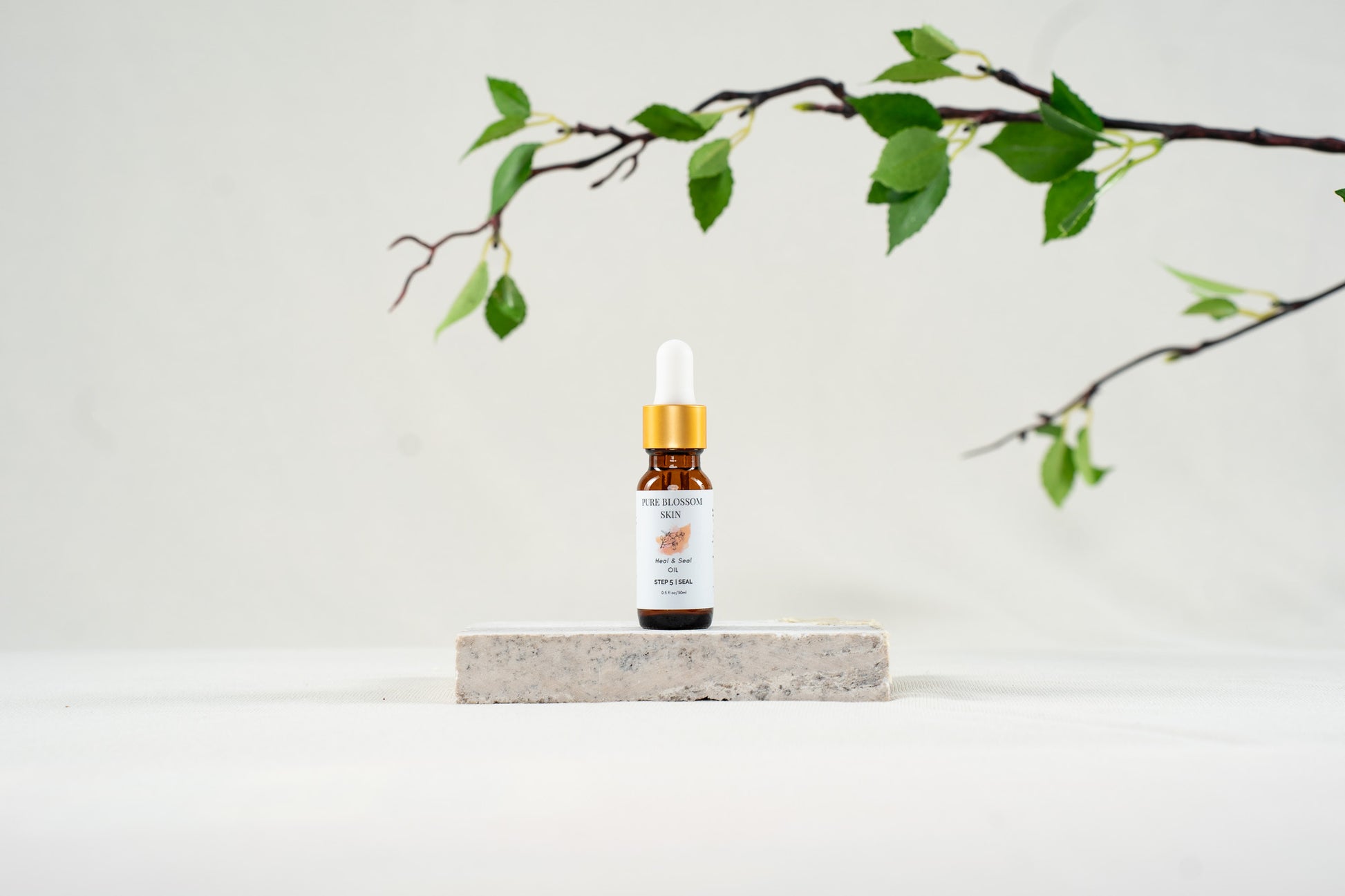 1/2oz amber glass bottle with gold trim dropper top of Heal & Seal OIL | Pure Blossom Skin