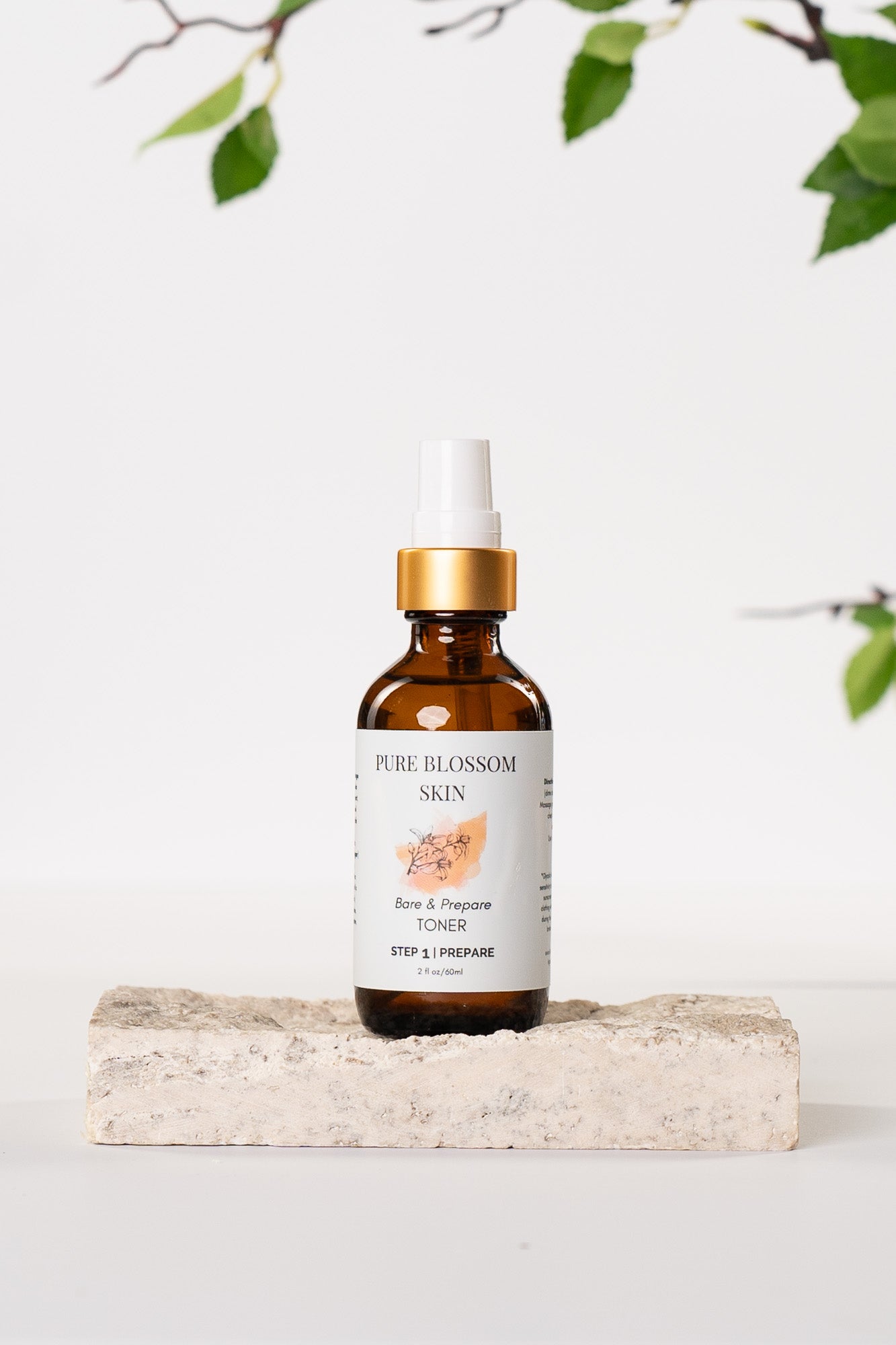 2 oz amber glass bottle with w/matte gold trim of Bare & Prepare TONER | Pure Blossom Skin