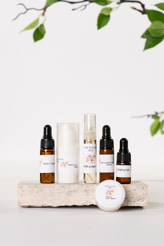 3 small amber glass bottles, 1 small 5g white opaque pump bottle, and 1 5g jar w/white lid sample sizes of all 6 products | Pure Blossom Skin